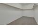 Walk-in closet featuring built-in shelving and carpeted flooring at 5713 Silver Cascade Ave, Las Vegas, NV 89131