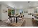 Bright dining area features a modern light fixture, ample space, and sliding glass door to the backyard at 5713 Silver Cascade Ave, Las Vegas, NV 89131