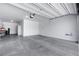 Spacious garage with concrete floor, storage areas and roll up garage door at 5713 Silver Cascade Ave, Las Vegas, NV 89131