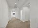 Spacious hallway with neutral carpeting and white walls, leading to other rooms at 5713 Silver Cascade Ave, Las Vegas, NV 89131