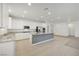 Bright kitchen with white cabinets, stainless appliances, island, and tile flooring at 5713 Silver Cascade Ave, Las Vegas, NV 89131