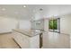 Open kitchen and living space with island, tile floors, and sliding glass doors at 5713 Silver Cascade Ave, Las Vegas, NV 89131