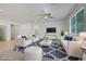 Bright living room features modern decor, large window, and ceiling fan for comfortable living at 5713 Silver Cascade Ave, Las Vegas, NV 89131