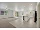 Open-concept living room and kitchen area, features sleek tile and bright natural light at 5713 Silver Cascade Ave, Las Vegas, NV 89131