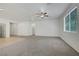 Spacious living room with neutral carpet and bright natural light from the window at 5713 Silver Cascade Ave, Las Vegas, NV 89131