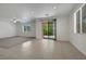 Large living space featuring access to the back patio, neutral tile flooring, and lots of natural light at 5713 Silver Cascade Ave, Las Vegas, NV 89131