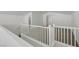 Upstairs loft area features neutral carpet, white walls, and a view of other rooms through the railing at 5713 Silver Cascade Ave, Las Vegas, NV 89131