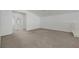 Upstairs loft area with neutral carpet and white walls has lots of open space and natural light at 5713 Silver Cascade Ave, Las Vegas, NV 89131