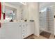 Bathroom featuring double sinks, white cabinets and tiled floors at 5900 Red Umber Ave, Las Vegas, NV 89130