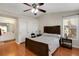 Bedroom featuring wood floors, ceiling fan, and en-suite bathroom for added privacy at 5900 Red Umber Ave, Las Vegas, NV 89130