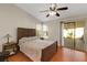 Bedroom featuring wood floors, vaulted ceilings and a sliding glass door to the patio at 5900 Red Umber Ave, Las Vegas, NV 89130