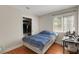 Bedroom featuring wood floors, closet and a window overlooking the backyard at 5900 Red Umber Ave, Las Vegas, NV 89130