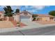 Single-story home with a two-car garage and desert landscaping at 5900 Red Umber Ave, Las Vegas, NV 89130