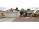 Single story home with desert landscaping, covered porch, dormer windows and a two car garage at 5900 Red Umber Ave, Las Vegas, NV 89130