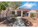 Inviting covered front porch with desert landscaping and a charming entryway at 5900 Red Umber Ave, Las Vegas, NV 89130