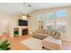 Comfortable living room features a fireplace, ceiling fan, and large windows at 5900 Red Umber Ave, Las Vegas, NV 89130