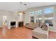 Open living room with tile flooring, fireplace, and large windows for natural light at 5900 Red Umber Ave, Las Vegas, NV 89130