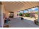 Covered patio offers respite with its desert landscaping and views of mature trees at 5900 Red Umber Ave, Las Vegas, NV 89130
