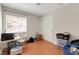 Empty room with wood floors, closet and a window overlooking the backyard at 5900 Red Umber Ave, Las Vegas, NV 89130