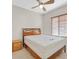 Bedroom featuring ceiling fan, window, wooden bed frame, and side table at 6001 Falconer Ave, Las Vegas, NV 89122