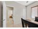 Bedroom featuring a window, ceiling fan, and door leading into another room at 6001 Falconer Ave, Las Vegas, NV 89122