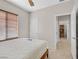 Bedroom featuring window, ceiling fan, and door leading into another room at 6001 Falconer Ave, Las Vegas, NV 89122