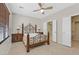 Bedroom featuring decorative iron bed frame, ceiling fan, and ensuite bathroom entrance at 6001 Falconer Ave, Las Vegas, NV 89122