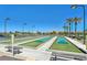 Bocce ball courts surrounded by desert landscaping, palm trees, and mountain views at 6001 Falconer Ave, Las Vegas, NV 89122