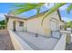 Side view of a well-maintained single-story home with a concrete yard and a two-car garage at 6001 Falconer Ave, Las Vegas, NV 89122