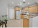 Spacious kitchen with granite countertops, wooden cabinets, and modern appliances at 6001 Falconer Ave, Las Vegas, NV 89122