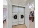 Convenient laundry closet with washer, dryer, and upper cabinets, accessed via open doors at 6001 Falconer Ave, Las Vegas, NV 89122
