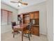 Inviting office space with a beautiful built-in desk, shelving, and decorative ceiling fan at 6001 Falconer Ave, Las Vegas, NV 89122