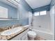 Well-lit bathroom features a shower-tub combination and a granite countertop sink at 632 Arrayo Way, Boulder City, NV 89005