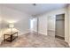 Bright bedroom features tile flooring, closet with mirrored doors, and a modern side table lamp at 632 Arrayo Way, Boulder City, NV 89005