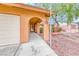 Covered front porch and walkway leading to the front door and attached garage at 632 Arrayo Way, Boulder City, NV 89005
