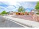 Front exterior view showcasing mature landscaping, desert landscaping and large driveway at 632 Arrayo Way, Boulder City, NV 89005