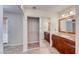 An ensuite bathroom featuring a double vanity, mirrored closet and safe step walk-in tub at 632 Arrayo Way, Boulder City, NV 89005