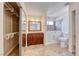 The main bathroom includes a walk in tub, vanity and walk-in closet with shelving at 632 Arrayo Way, Boulder City, NV 89005