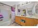 Bright bathroom featuring double sinks, bathtub and shower combo, plus ample counter space at 6928 Smiling Cloud Ave, Henderson, NV 89011
