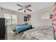 Comfortable bedroom featuring carpet, ceiling fan, plus a window that provides natural light at 6928 Smiling Cloud Ave, Henderson, NV 89011