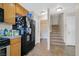 Kitchen with tile floors, wooden cabinets, and a black refrigerator at 6928 Smiling Cloud Ave, Henderson, NV 89011