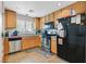 Kitchen with stainless steel appliances, wooden cabinets, and tile flooring at 6928 Smiling Cloud Ave, Henderson, NV 89011