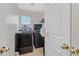 The laundry area has tile floors, a window, newer washer and dryer, and storage shelving at 6928 Smiling Cloud Ave, Henderson, NV 89011