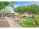 Community green space featuring grassy area, picnic benches and mature trees and walking paths at 6928 Smiling Cloud Ave, Henderson, NV 89011