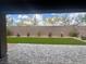 Serene backyard featuring a patio, artificial turf, and a brick wall adorned with rose bushes at 7527 Ardenno St, North Las Vegas, NV 89084