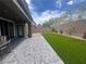 Beautiful outdoor space with a stone patio, artificial grass, and well-maintained landscaping at 7527 Ardenno St, North Las Vegas, NV 89084