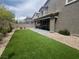 Expansive backyard with artificial grass and a covered patio perfect for outdoor entertaining at 7527 Ardenno St, North Las Vegas, NV 89084