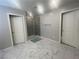 Clean bathroom with marble flooring and a glass enclosed shower at 7527 Ardenno St, North Las Vegas, NV 89084