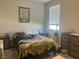 Comfortable bedroom with neutral tones, large window, and classic furniture at 7527 Ardenno St, North Las Vegas, NV 89084