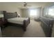 Comfortable bedroom with neutral tones, large window, and classic furniture at 7527 Ardenno St, North Las Vegas, NV 89084